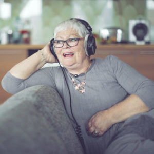 Senior woman at home listening music